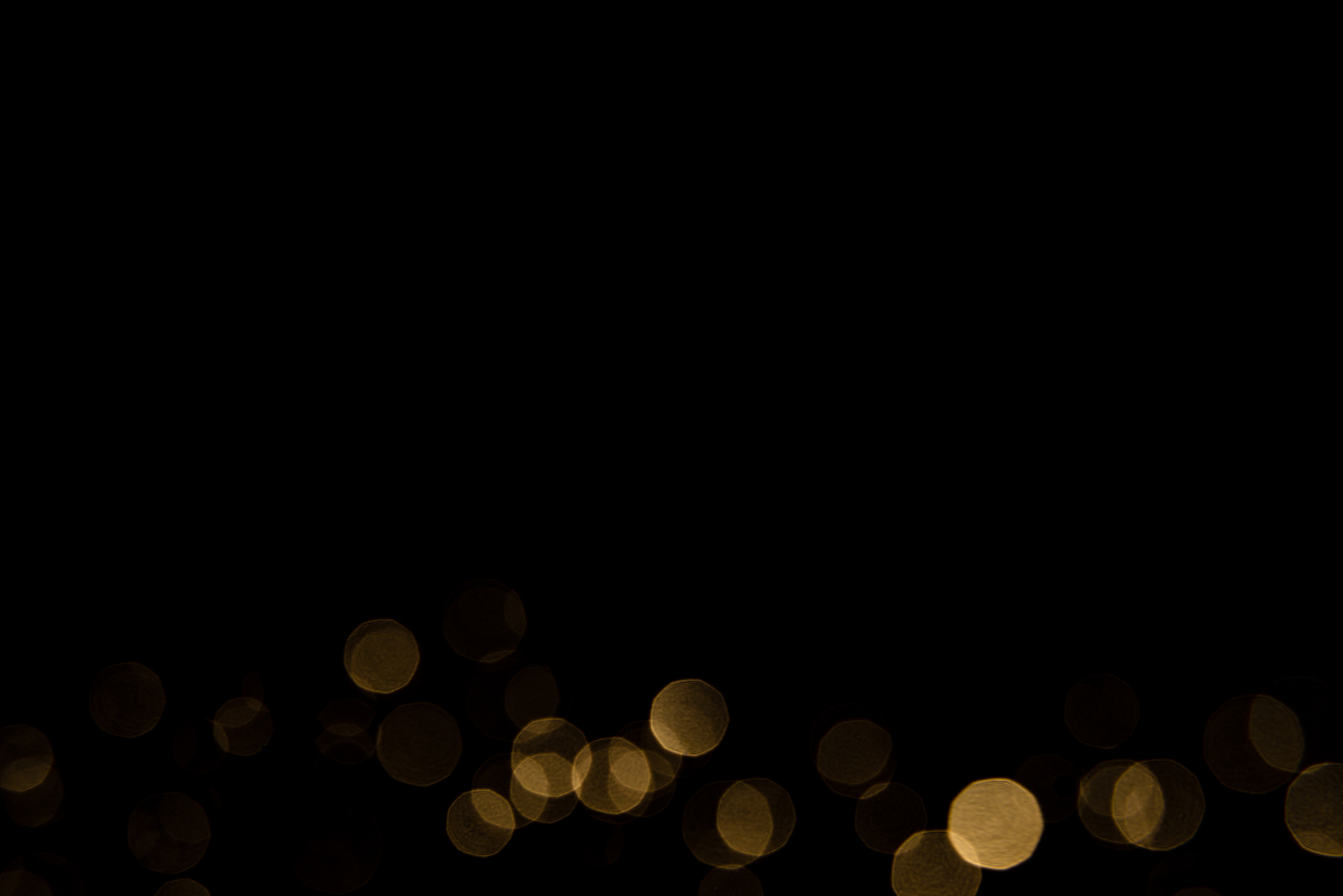 Abstract gold bokeh with black background